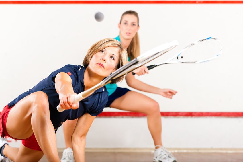 two women playing squash