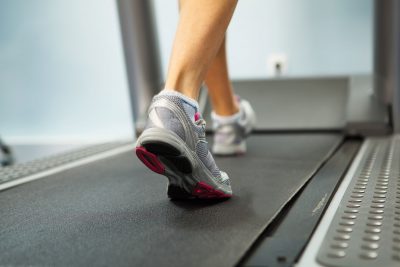 female foot running on treadmill